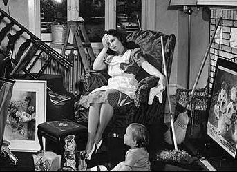 A housewife sits in an armchair in a messy room.