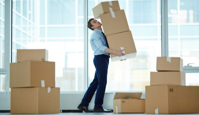 Businessman_moving_boxes Business man moving boxes around a room