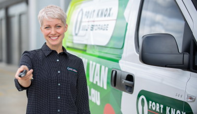VanKeys Fort Knox storage expert handing over van keys next to free move in van.