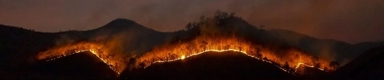 Wildfire burning across hills at night