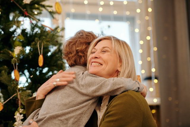 Grandmother hugging grandchild at christmas